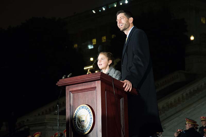 10-year old Anna DeVolld of Alaska and House Speaker Paul Ryan light the tree