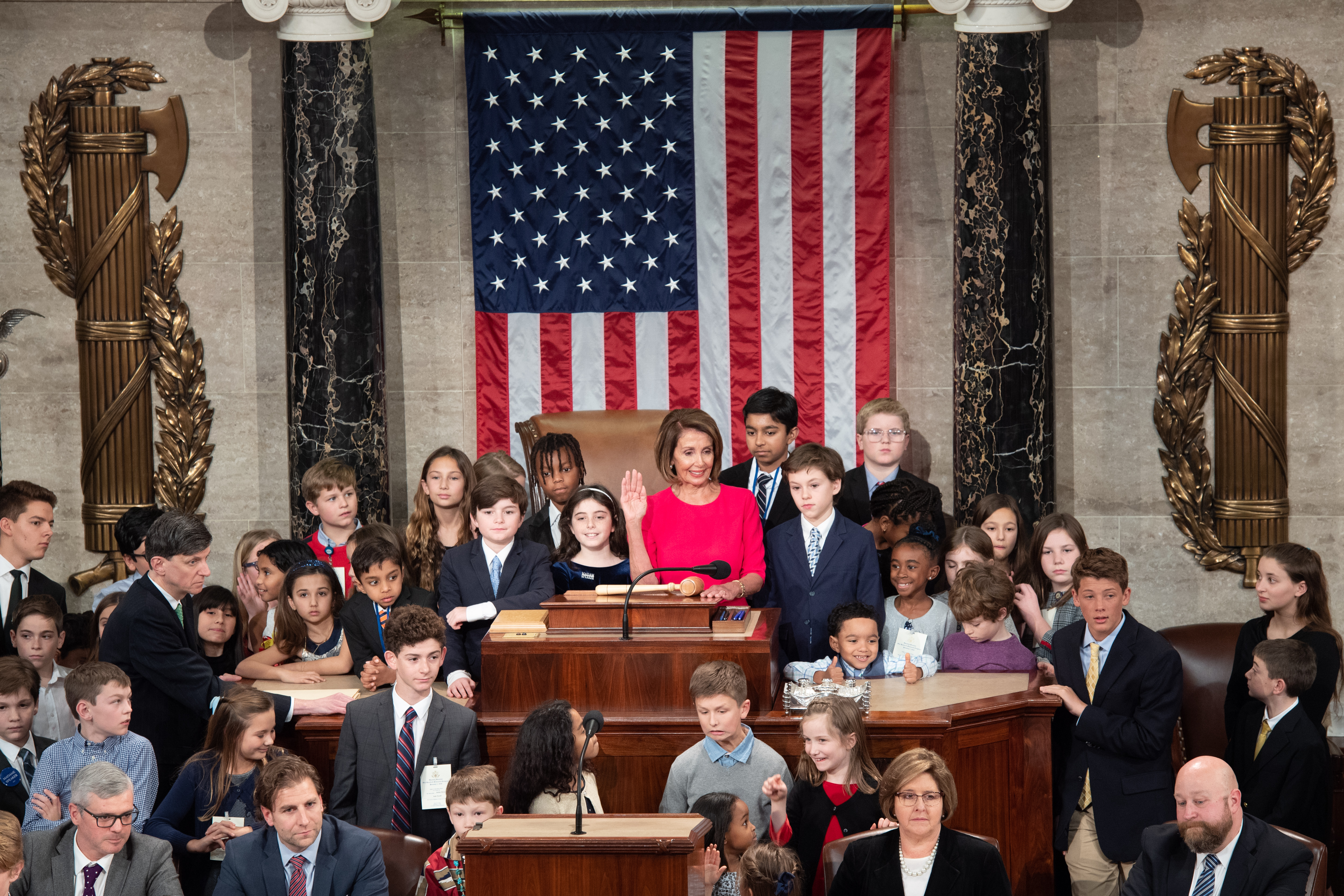 Incoming Speaker Nancy Pelosi takes the oath of office surrounded by children of Members.