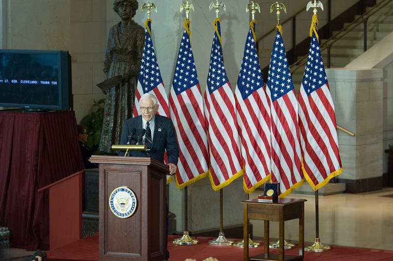 Lt. General Charles Cleveland accepts the medal on the pilots' behalf