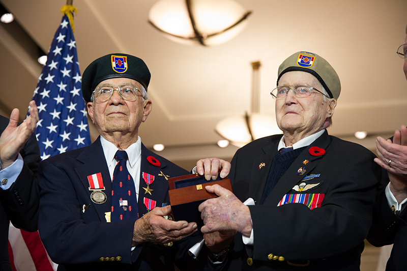 Canadian Charles W. Mann and American Eugene Gutierrez Jr. holding a medal