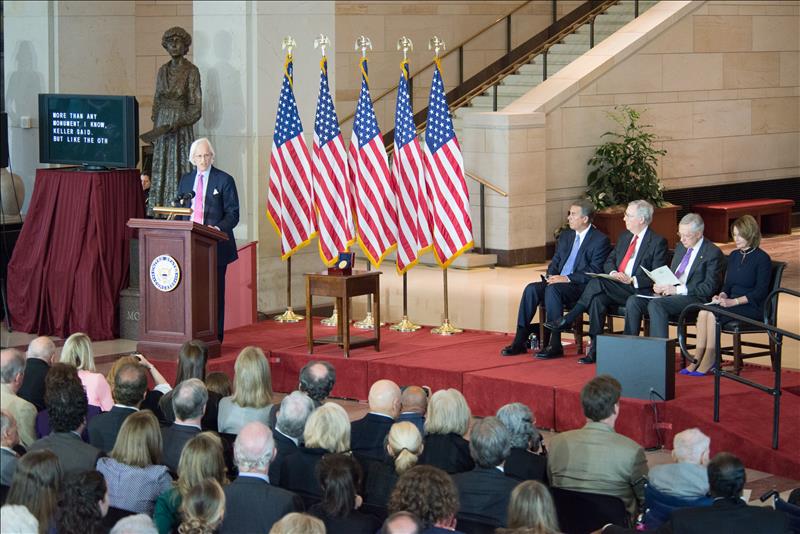 Monuments Men Foundation for the Preservation of Art Chairman Robert Edsel standing behind a podium