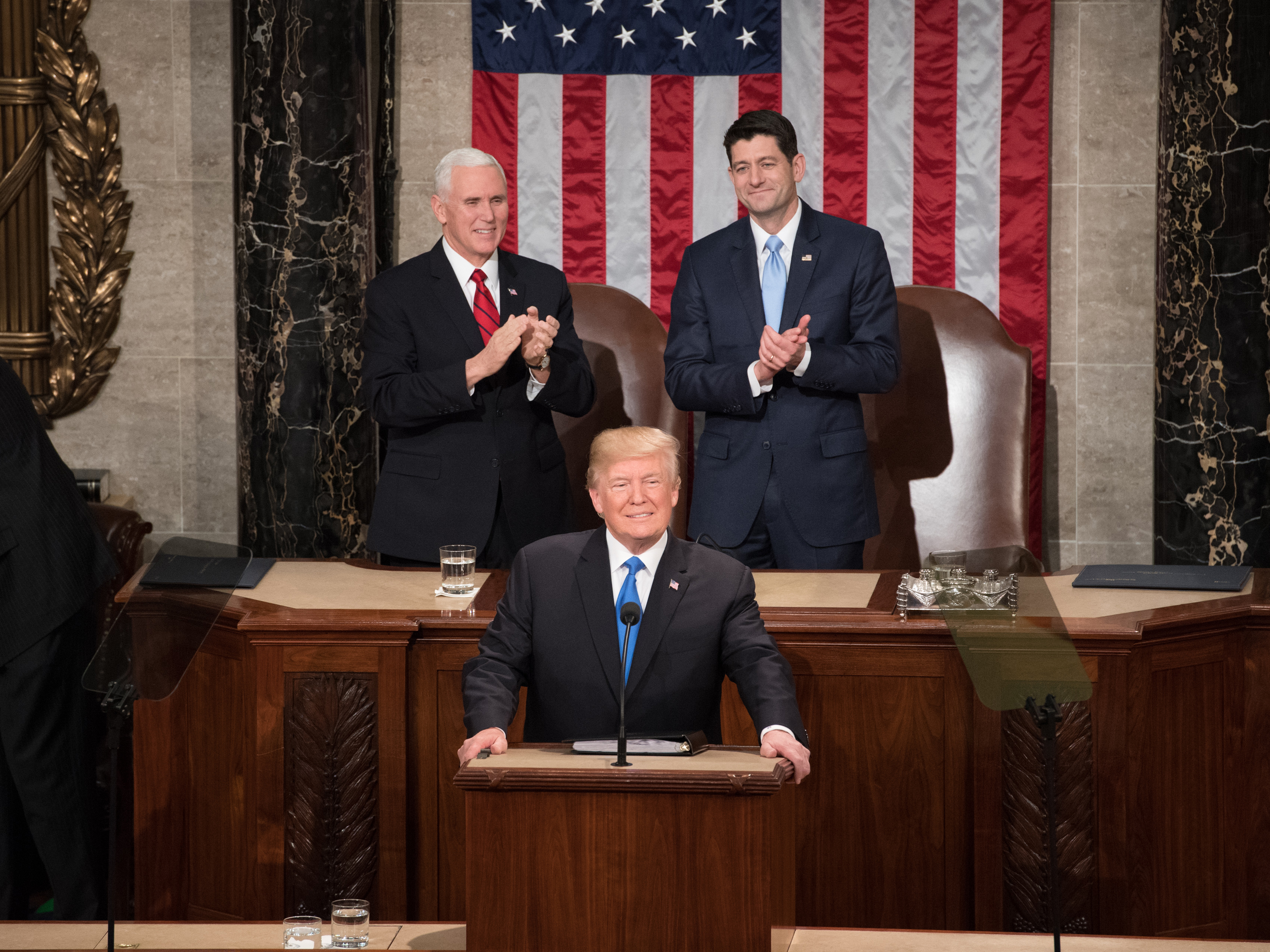 President Donald Trump flanked by Vice President Mike Pence and Speaker Paul Ryan