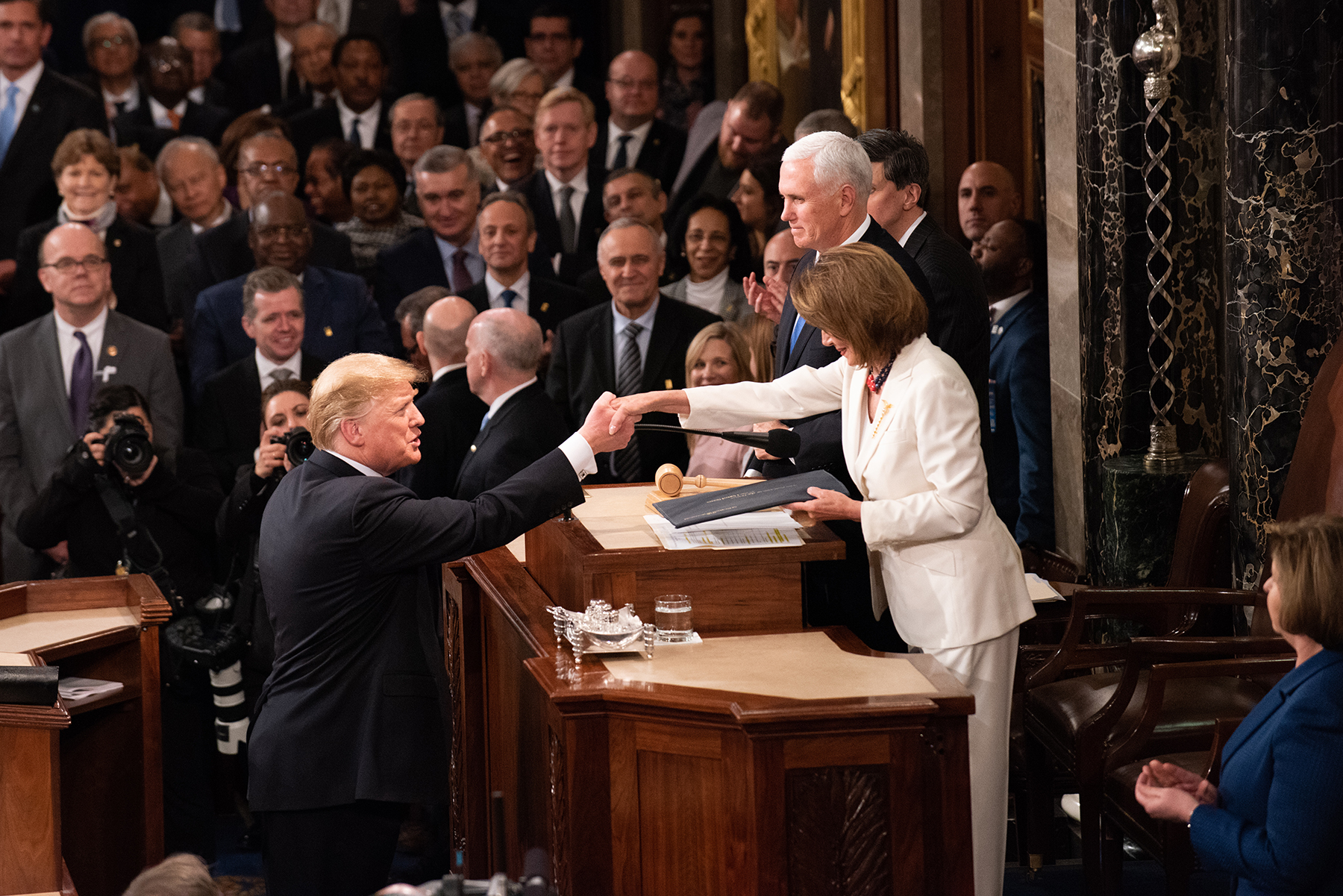 President Donald Trump shakes hands with U.S. House of Representatives Speaker Nancy Pelosi