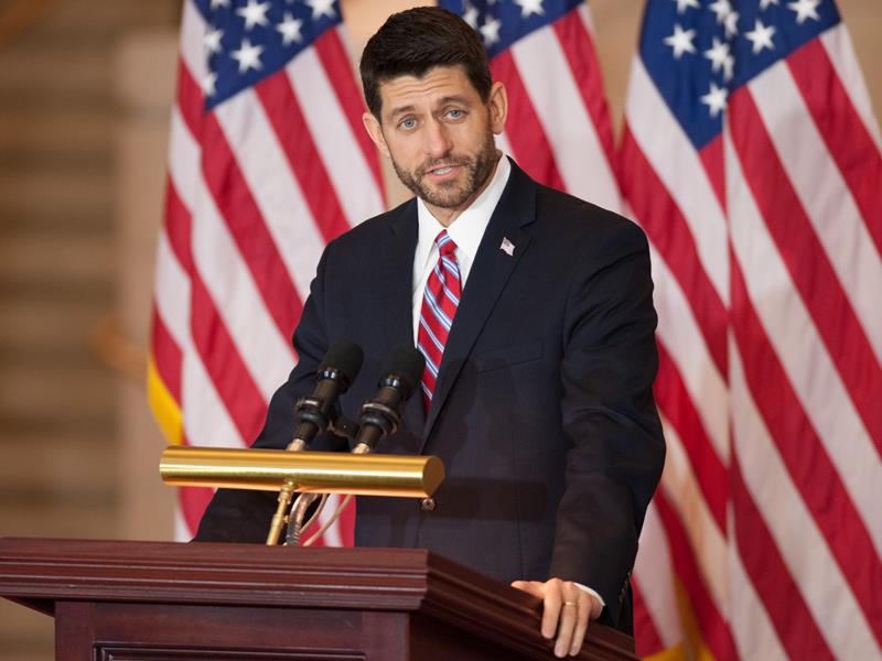 House Speaker Paul Ryan standing behind a podium