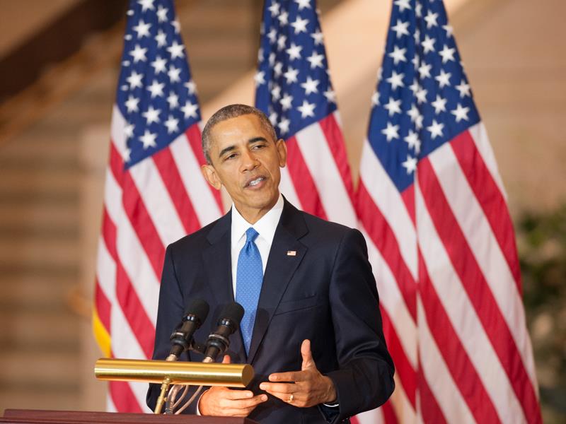 President Obama standing behind a podium